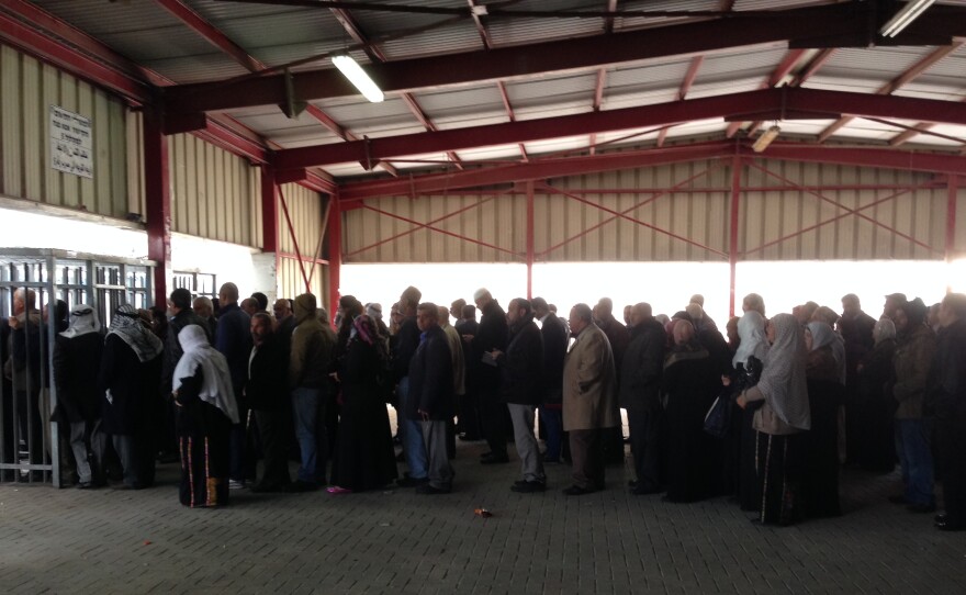 Palestinians line up at the Qalandia checkpoint between Ramallah and Jerusalem on a recent morning. Since Israel stopped requiring older Palestinians to obtain permits in advance, crowds have been growing, particularly on Friday when Muslims want to pray at Al-Aqsa mosque in Jerusalem.