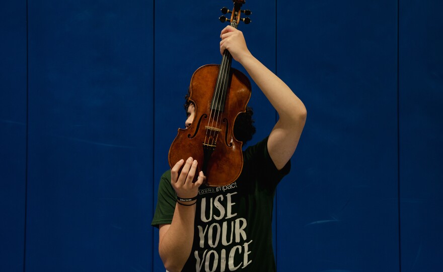 A Northern Virginia Juvenile Detention Center resident holds a viola after his final performance in Sound Impact's "Use Your Voice" residency.
