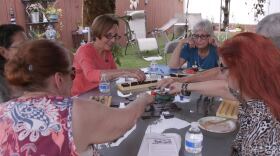 Agnes Conradt and Evie Kosower play Mexican train with their neighbors, Oct. 12, 2015.
