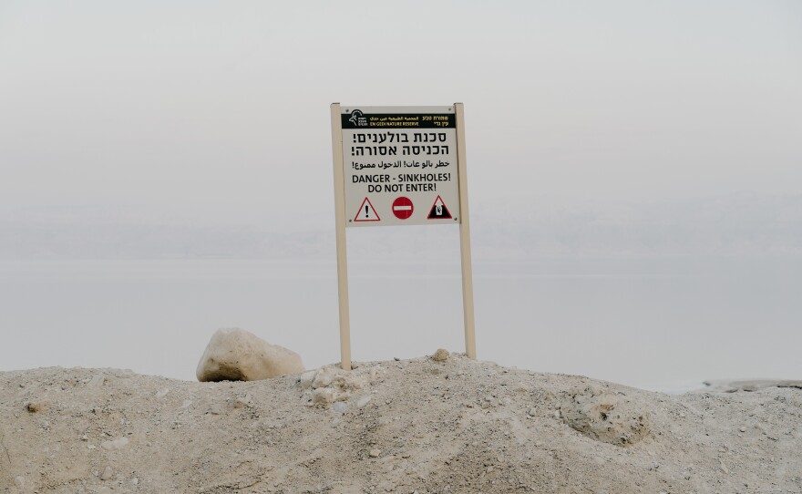 A sign warning of sinkholes near the Dead Sea.