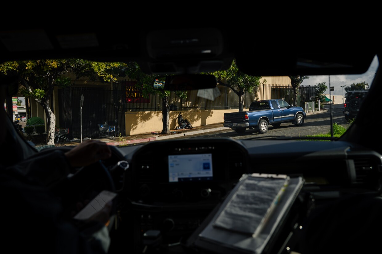 Qiana Williamson and Hector Hueso, the two members of National City’s Homeless Outreach and Mobile Engagement (HOME) team, talk with residents experiencing homelessness in parts of the city on March 7, 2024. National City is the second in San Diego County to move away from a police-led response to homelessness and toward trained caseworkers.
