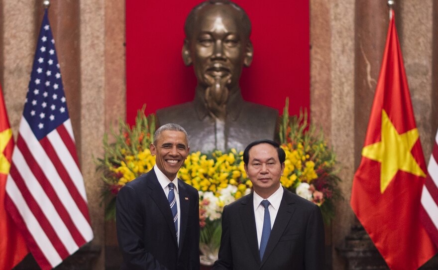 President Obama shakes hands with Vietnamese President Tran Dai Quang at the Presidential Palace in Hanoi on Monday. Obama's Vietnam trip is the latest in a series of moves reaching out to old U.S. rivals.