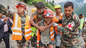 In this photo provided by the Nepal Army, soldiers rescue a worker alive from a tunnel during an ongoing operation at the Trishuli-3A hydropower project in Nepal's Rasuwa district, Friday, Sept. 4, 2026.