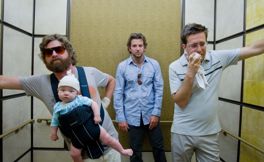 Zach Galifianakis, Bradley Cooper, and Ed Helms are three men and a baby in Vegas in "The Hangover"