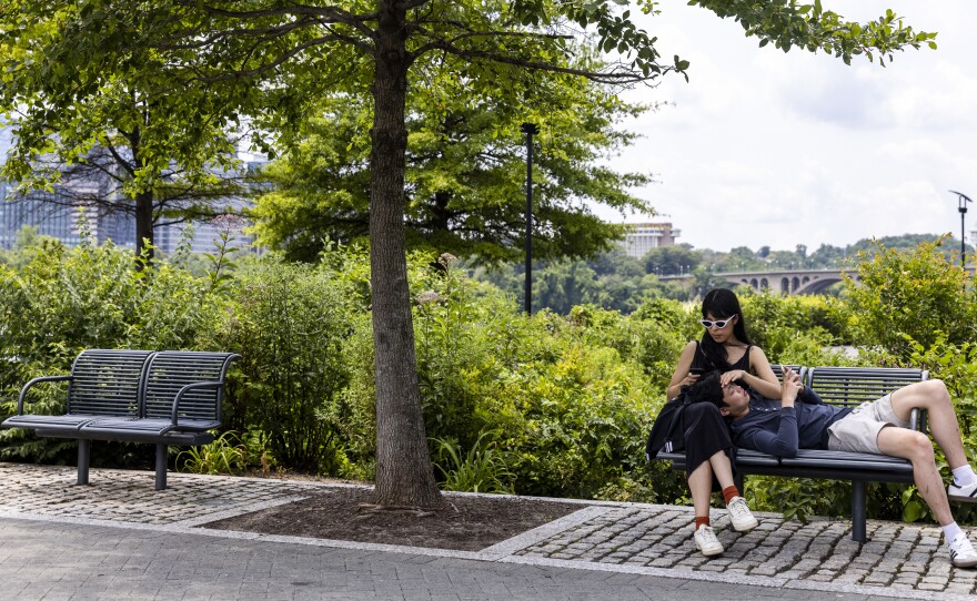 People relax at the Georgetown Waterfront Park on Monday in Washington, D.C. While pandemic restrictions have been lifted for much of the country, the Delta variant of COVID-19 is hospitalizing thousands of people in the U.S. who have so far not gotten a vaccine.