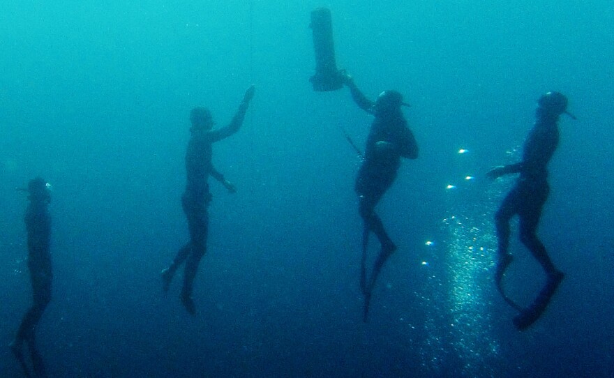 Polish freediver Mateusz Malina, second from right, accompanied by judges and safety divers, at the Little Blue Hole freediving competition in Dahab, Egypt, last month. Malina blacked out on this dive, but on the previous day broke the Polish national record for freediving without fins by diving 272 feet.