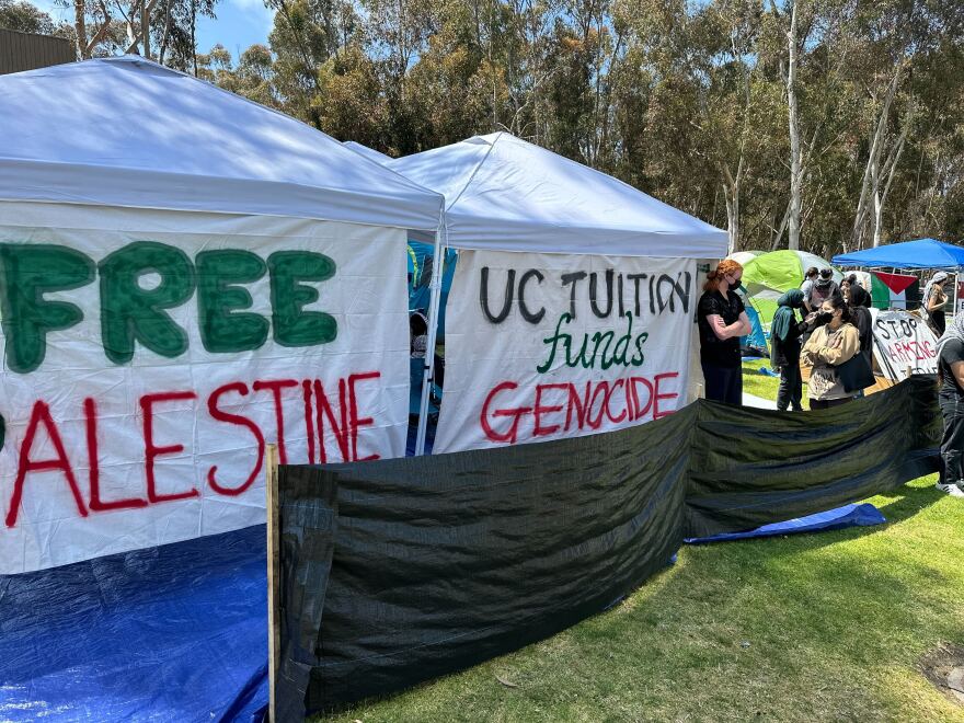 Signs outside the "Gaza Solidarity" encampment at UC San Diego read "Free Palestine" and "UC tuition funds genocide." La Jolla, Calif. May 1, 2024.