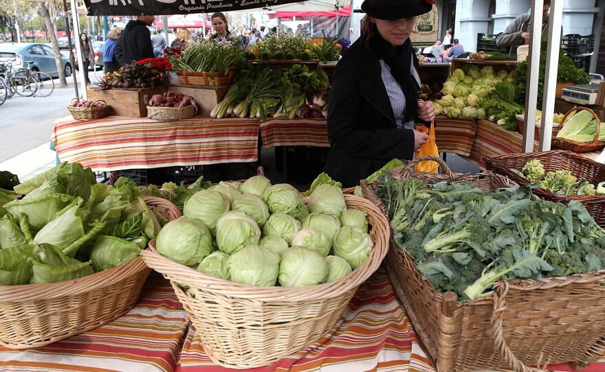 A customer shops for produce at the Ferry Plaza Farmers Market in San Francisco in March.