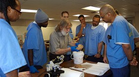 Charles Gross, a neuroscience professor at Princeton University, looks at a sheep brain with students at San Quentin as part of an Introduction to Biology class at the prison.