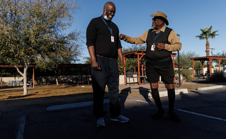 Roommates Ricky Jones, 69, (right) and Richard Crumbley, 63, make jokes after a roll call early morning at Grand Veterans Village in Phoenix.