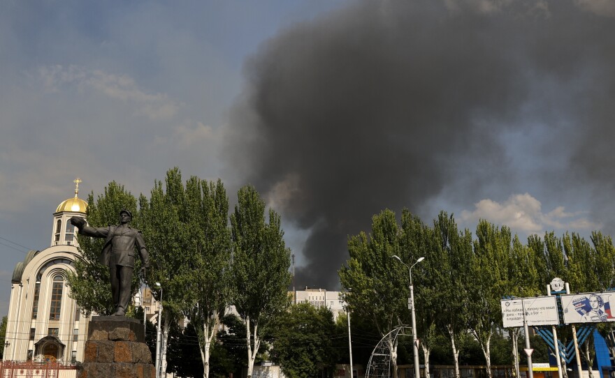 Smoke rises from a burning house following shelling in Donetsk, eastern Ukraine, on Friday.