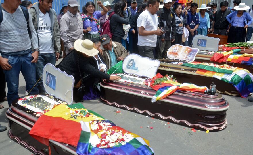 Relatives mourn by the coffins of supporters of Evo Morales killed during clashes with the police in Sacaba, Cochabamba, Bolivia, on Nov. 16, 2019.