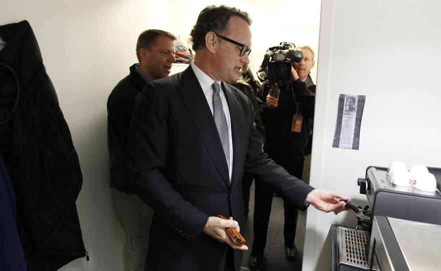 Tom Hanks visits his old espresso machine during a visit to the White House March 11, 2010.