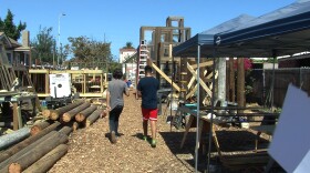 Student volunteers work on building a community gathering space with a treehouse and maze on Imperial Avenue in Logan Heights, Sept. 25, 2015.
