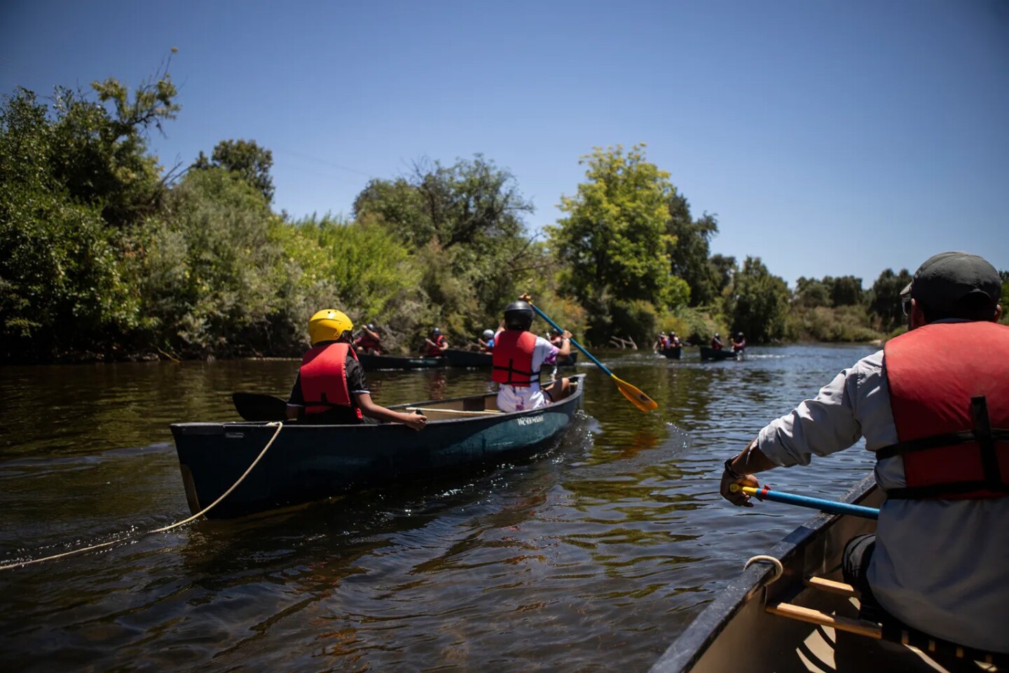 Students of the Migrant Outdoor Education Program canoe along the San Joaquin River near the Scout Island Education Center in Fresno on July 11, 2025.