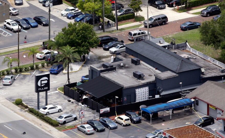 Law enforcement officials work at the scene of the Pulse Orlando nightclub.