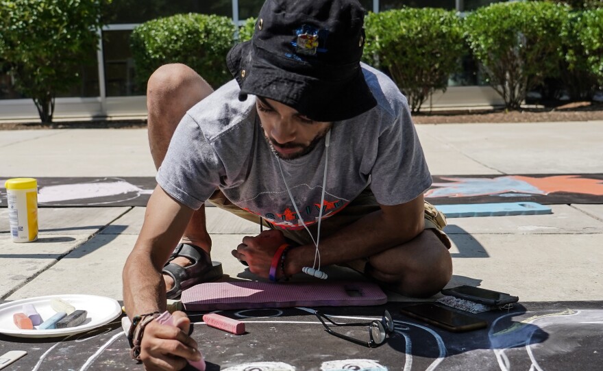 Alex Allen of Positive Chalk D.C. creates a Pokémon piece.