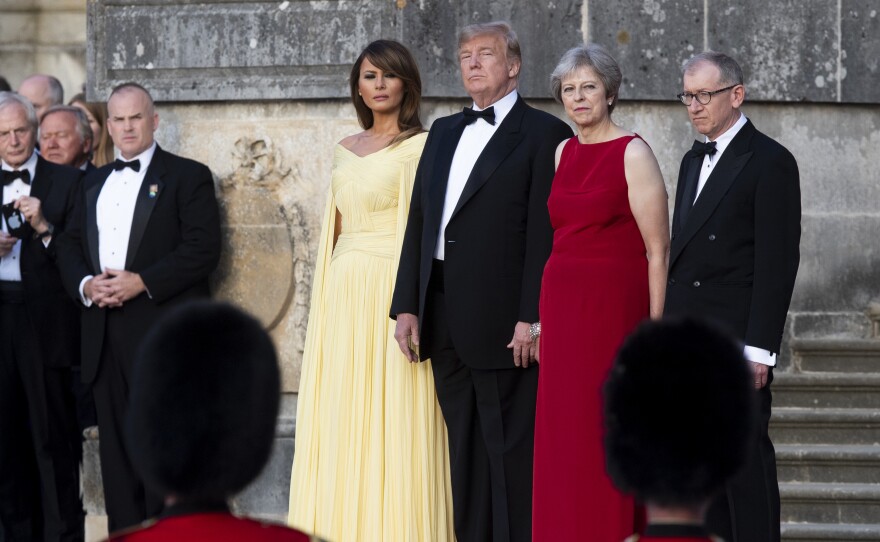 U.S. first lady Melania Trump, President Trump, British Prime Minister Theresa May and her husband, Philip May, watch a military performance ahead of a dinner in Oxfordshire, U.K., on Thursday.