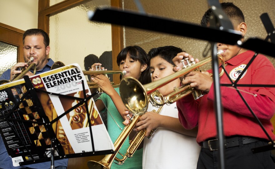 These students attend classes at Harmony Project's headquarters in Hollywood, Calif. The walls are thin; a few of the windows barely close. At 5 o'clock, staffers simply surrender their offices to the kids and their teachers. Forrest Powell, left, and his trumpet students are packed shoulder-to-shoulder in one office-turned-practice room.