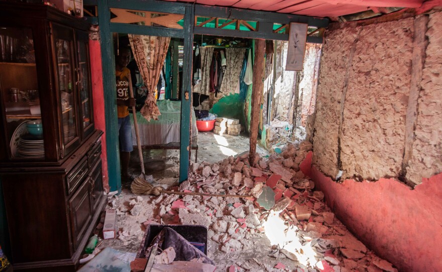 <strong data-stringify-type="bold">Mon., Aug. 16: </strong>A man cleans the debris at his house in Corvalion, Les Cayes, Haiti.