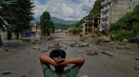 A boy looks at the devastation caused by flash flooding along the Trishuli River in Nepal's Nuwakot district on Wednesday.