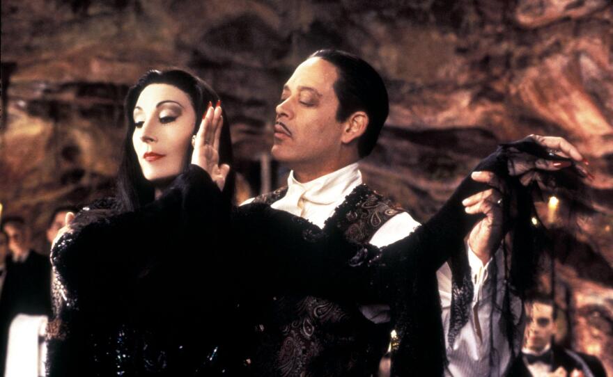 Anjelica Huston as Morticia Addams and Raul Julia as Gomez Addams in <em>Addams Family Values</em>.