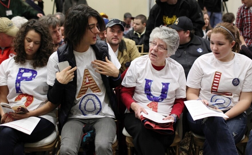 Supporters of Republican presidential hopeful Ron Paul rally for their candidate during a campaign stop Monday in Cedar Falls, Iowa.