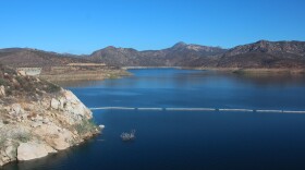 The San Vicente reservoir in San Diego County stores water from as far away as the Colorado River. Pumping water into a smaller reservoir in the surrounding mountains could store excess solar power until it's needed, when the sun sets.