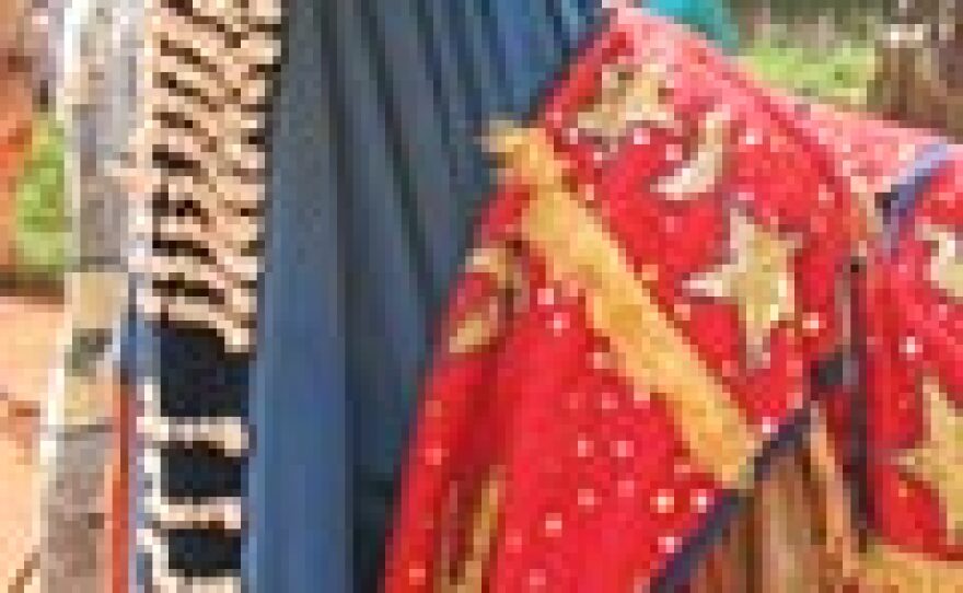 Hooded costume of an Egungun dancer adorned with cowrie shells.