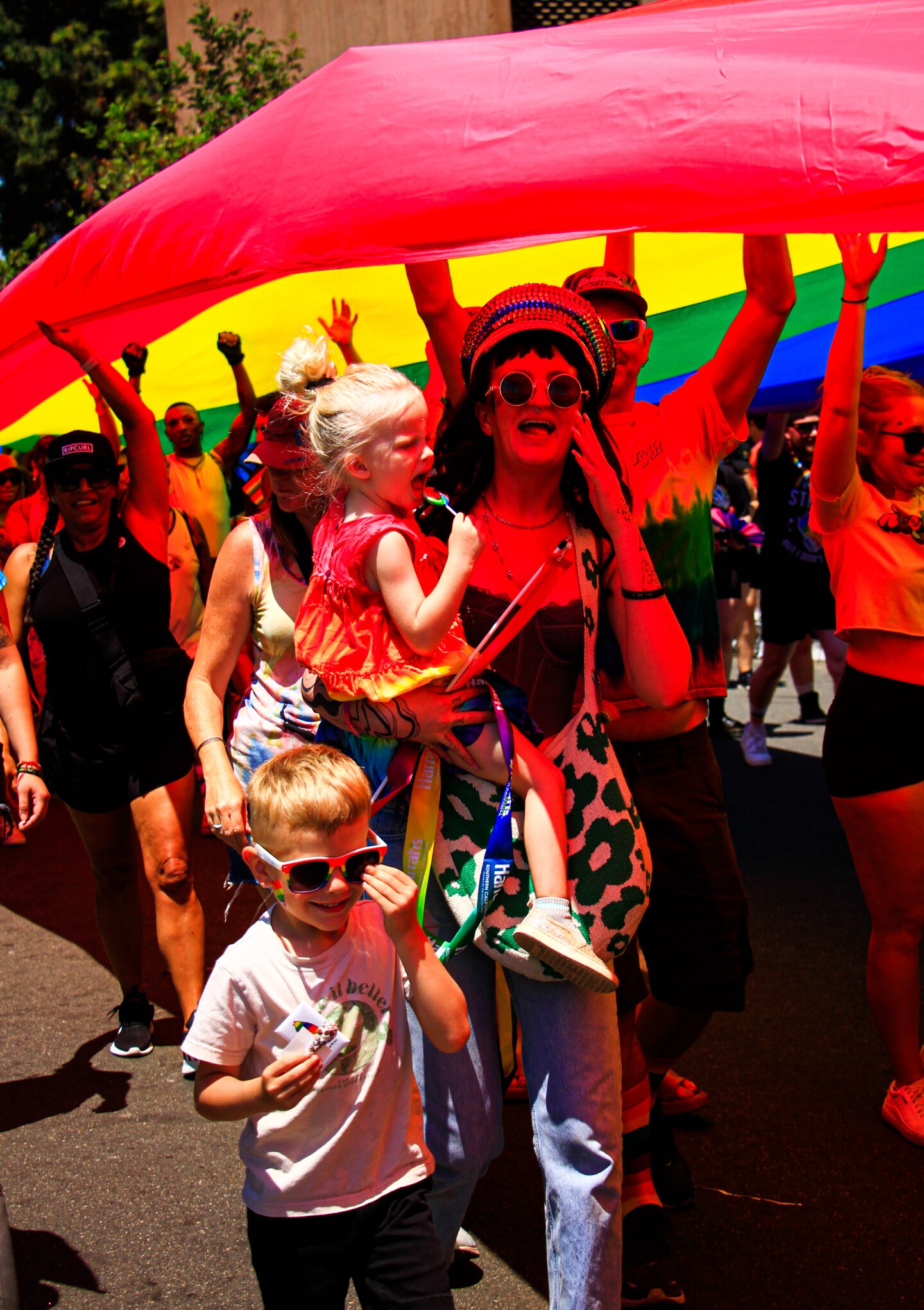 A woman and her children chant under a gigantic Pride flag, July 15, 2023.