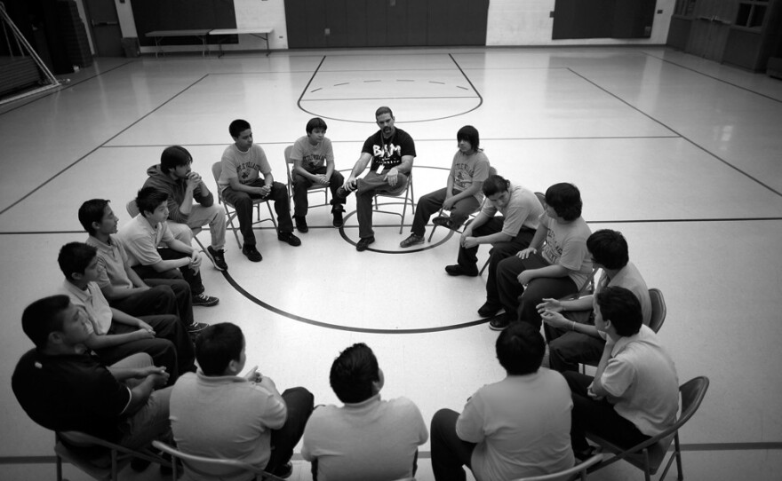 Participants in the Becoming a Man (BAM) program gather for a session in the gym at Little Village Academy in Chicago. BAM focuses on mentoring at-risk boys to prevent them from turning to violent crime.