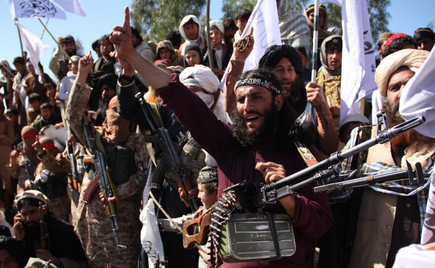 Afghan Taliban fighters and villagers attend a gathering in Laghman province, Alingar district, in March 2020 as they celebrate the peace deal signed between the U.S. and the Taliban.