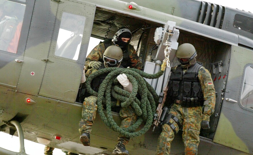Soldiers of the Command Special Forces (KSK) of the Bundeswehr are preparing to rappel from a helicopter during an exercise in 2004.