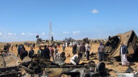 Locals on the road between Benghazi and Ajdabiya check  what's left from coalition airstrikes against forces loyal to Moammar Gadhafi.