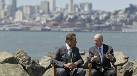 California Gov. Jerry Brown, right, and former Gov. Arnold Schwarzenegger, left, talk before a climate bill signing on Treasure Island, Tuesday, July 25, 2017. 