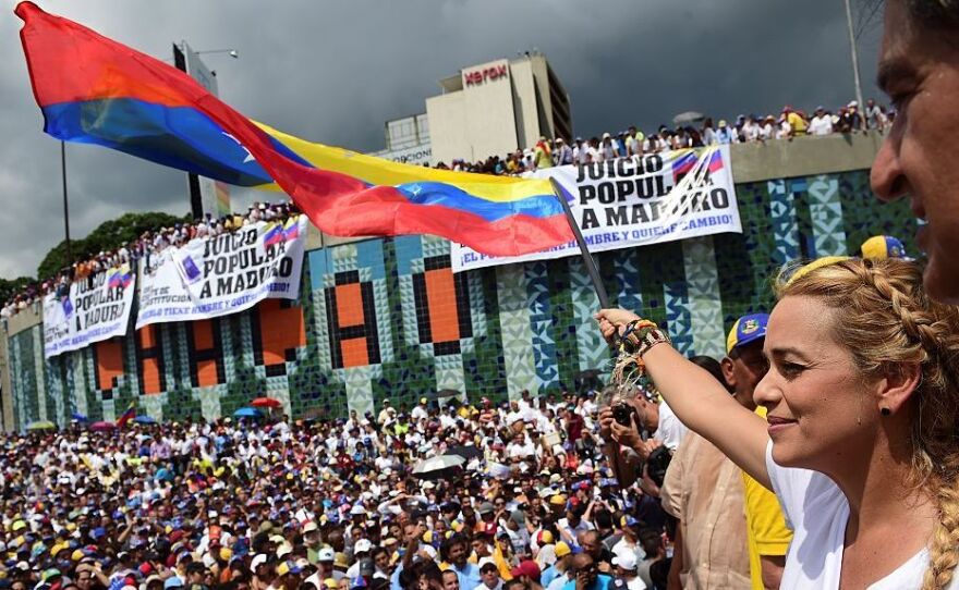 Lilian Tintori, wife of prominent jailed opposition leader Leopoldo Lopez, waves a Venezuelan flag during a rally against the government of President Nicolas Maduro in Caracas on Wednesday.