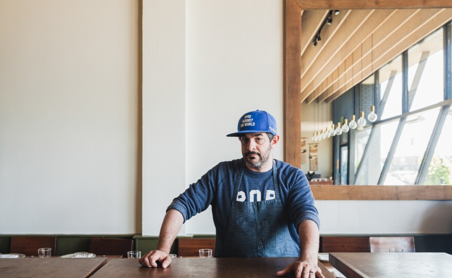 Fox at the Santa Monica restaurant, Rustic Canyon, where he's now head chef. Born in Cleveland, he proudly wears his 'Ohio Against the World' hat. And beneath his apron, the proud father of 16 month-old-daughter Birdie wears his "pop" sweatshirt.