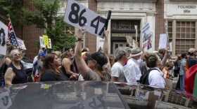A demonstrator holds up an "8647" sign at a "No Kings" protest in Louisville, Ky., in June 2025. It's an anti-Trump slogan, with multiple interpretations.
