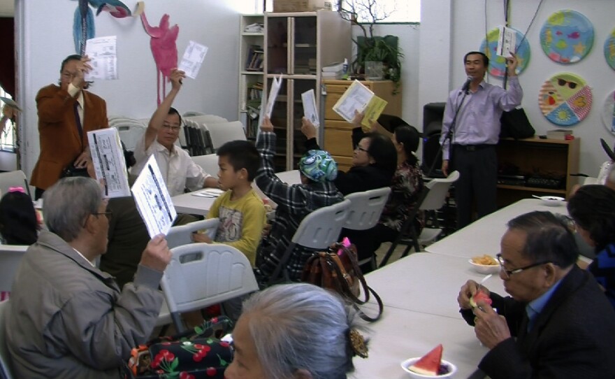 Members of the San Diego Living Water Church in City Heights hold up their ballots, May 22, 2016.