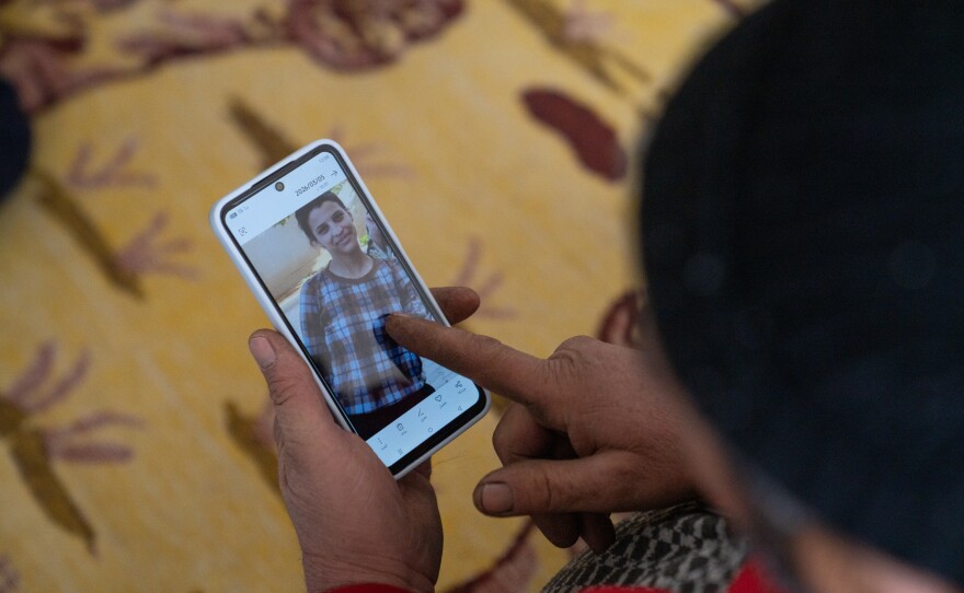 Said Mohammad Mustafa looks at pictures of his 15-year-old daughter, Zaynib, who he and his wife lost contact with after leaving the Tabqa displacement camp. Her body was later returned to them.