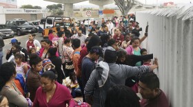 In this Monday, June 4, 2018 photo, people seeking political asylum in the United States line up to be interviewed in Tijuana, Mexico, just across the U.S. border south of San Diego.