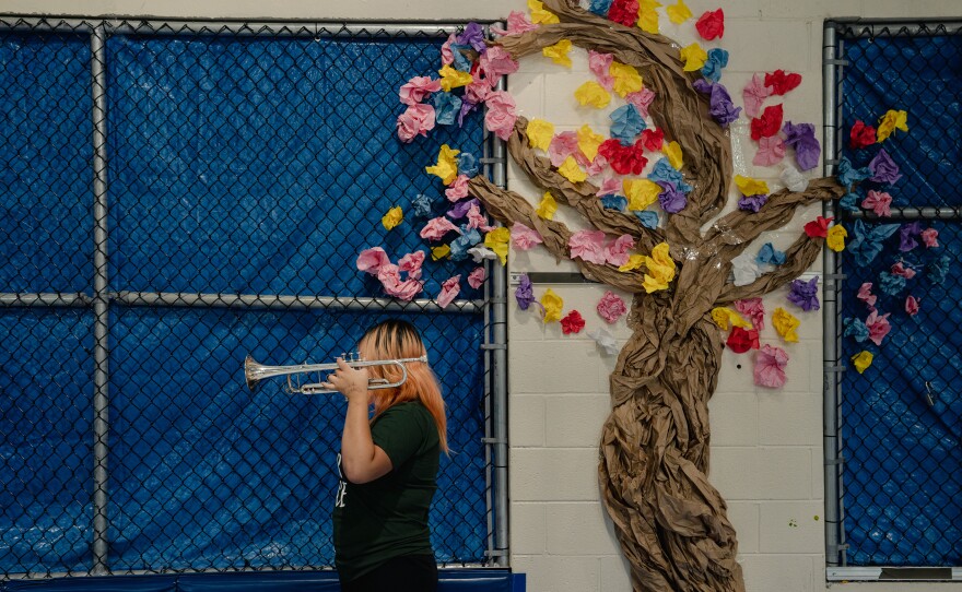 A Northern Virginia Juvenile Detention Center resident holds a trumpet after her final performance of the residency.