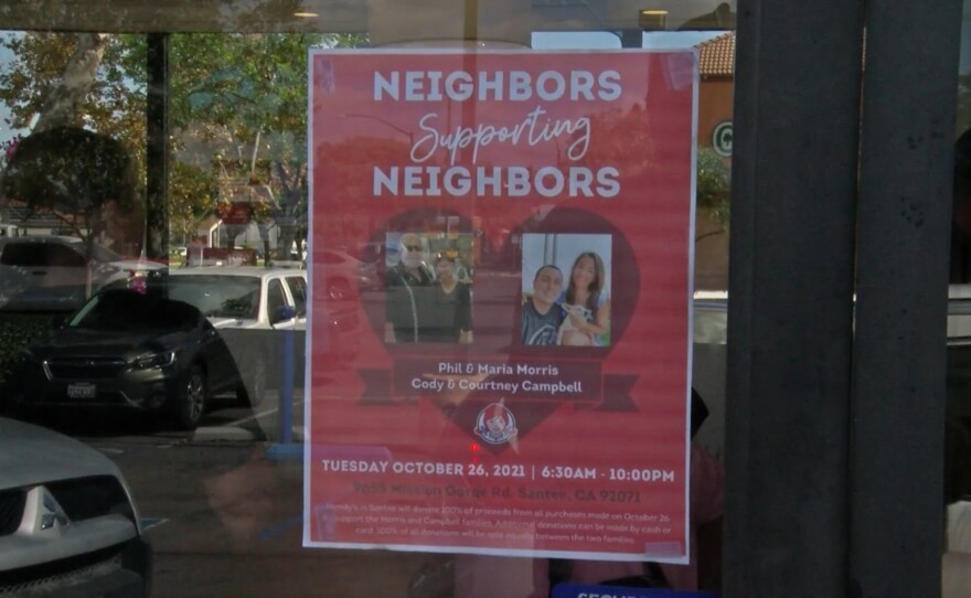 A sign outside a Wendy's restaurant in Santee reads "Neighbors Supporting Neighbors," Oct. 26, 2021. The restaurant is hosting a fundraiser for the two families affected by the Oct. 11, 2021, plane crash.