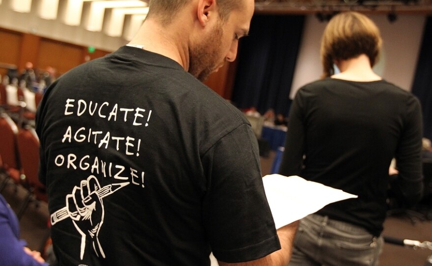 A student prepares to speak in opposition to proposed tuition increases at a University of California Board of Regents meeting in July 2011.