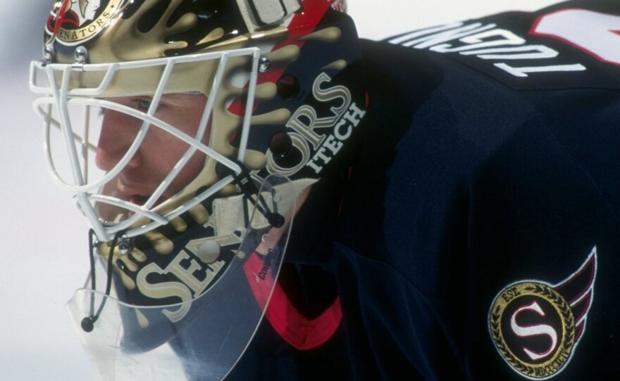 Ron Tugnutt, seen here playing for the Ottawa Senators in 1997, says he got the idea for a splash design a few years earlier while playing for the Montreal Canadiens, which was owned by the Molson family. For that reason the original idea was to mimic beer, but he continued to use the splash design (with new colors) for each of the teams he went on to play for.