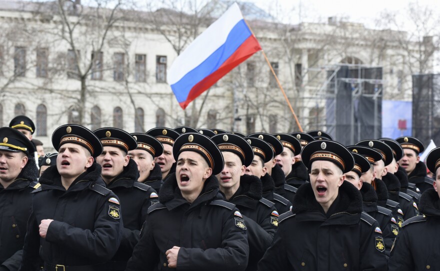 Russian Black Sea fleet sailors shout as they march in Sevastopol, Crimea, during a military parade last year marking the anniversary of the annexation of the Crimean Peninsula from Ukraine.