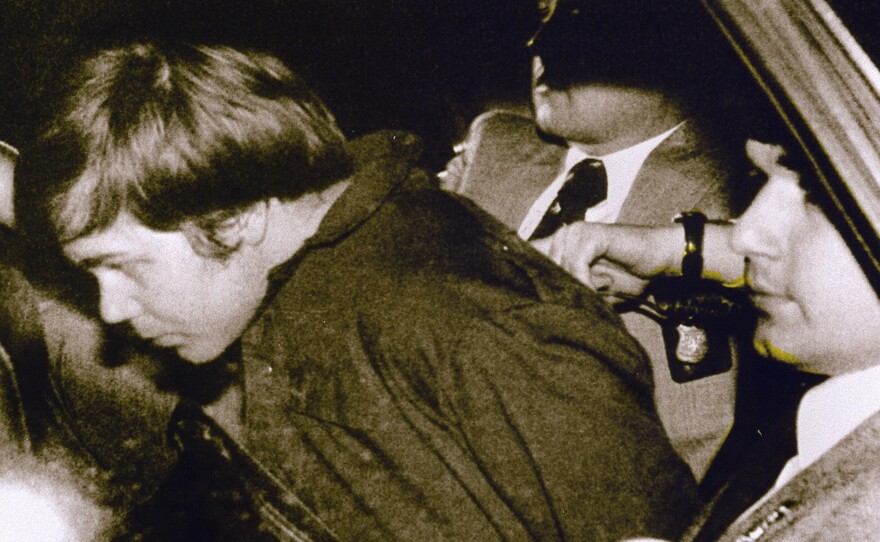 John Hinckley Jr. in 1981, escorted by police in Washington, DC, following his arrest after shooting and seriously wounding then-President Ronald Reagan. He was found not guilty by reason of insanity.