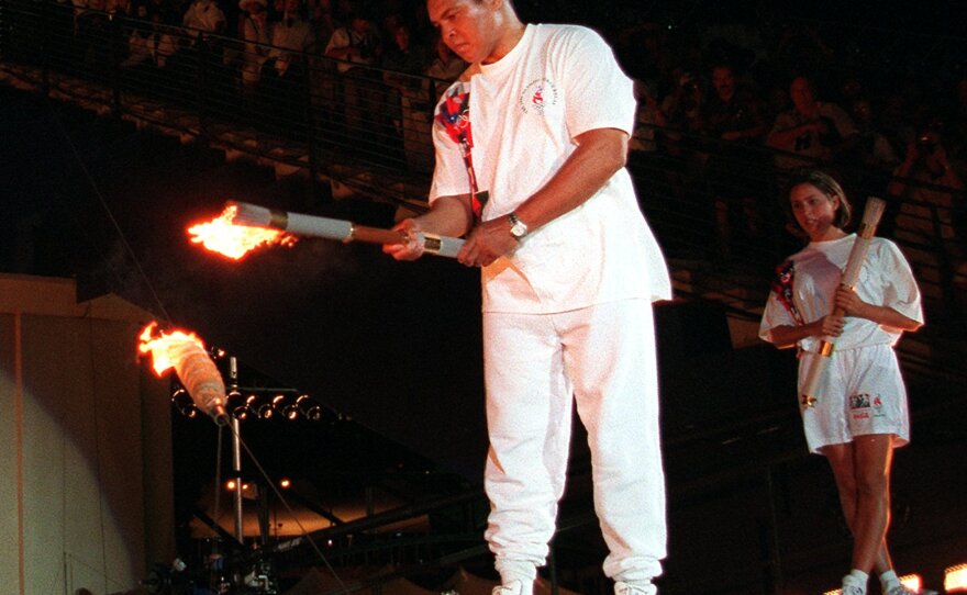 Muhammad Ali lights the Olympic flame during the 1996 Summer Olympic Games opening ceremony in Atlanta on July 19, 1996.