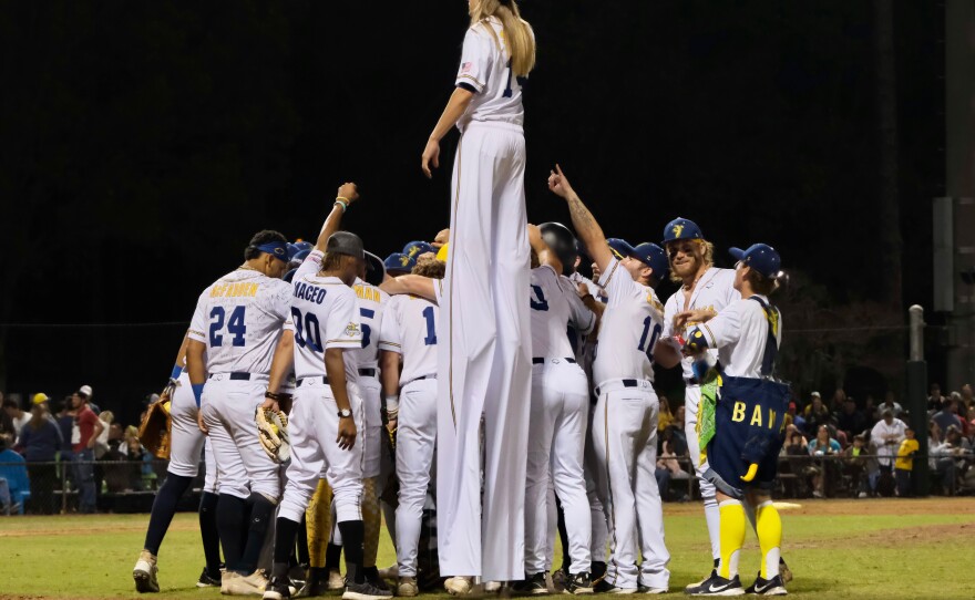 The Savannah Bananas huddle on the field at Grayson Stadium in Savannah, Georgia, before playing a team of retired Major League Baseball players on March 11, 2023.