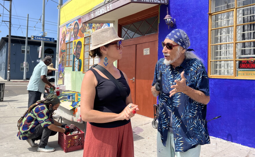 Mario Torero and his wife Sarah Mondragon stand in front of a mural at Clementine McDuff Elks Lodge in Logan Heights on July 28, 2026.